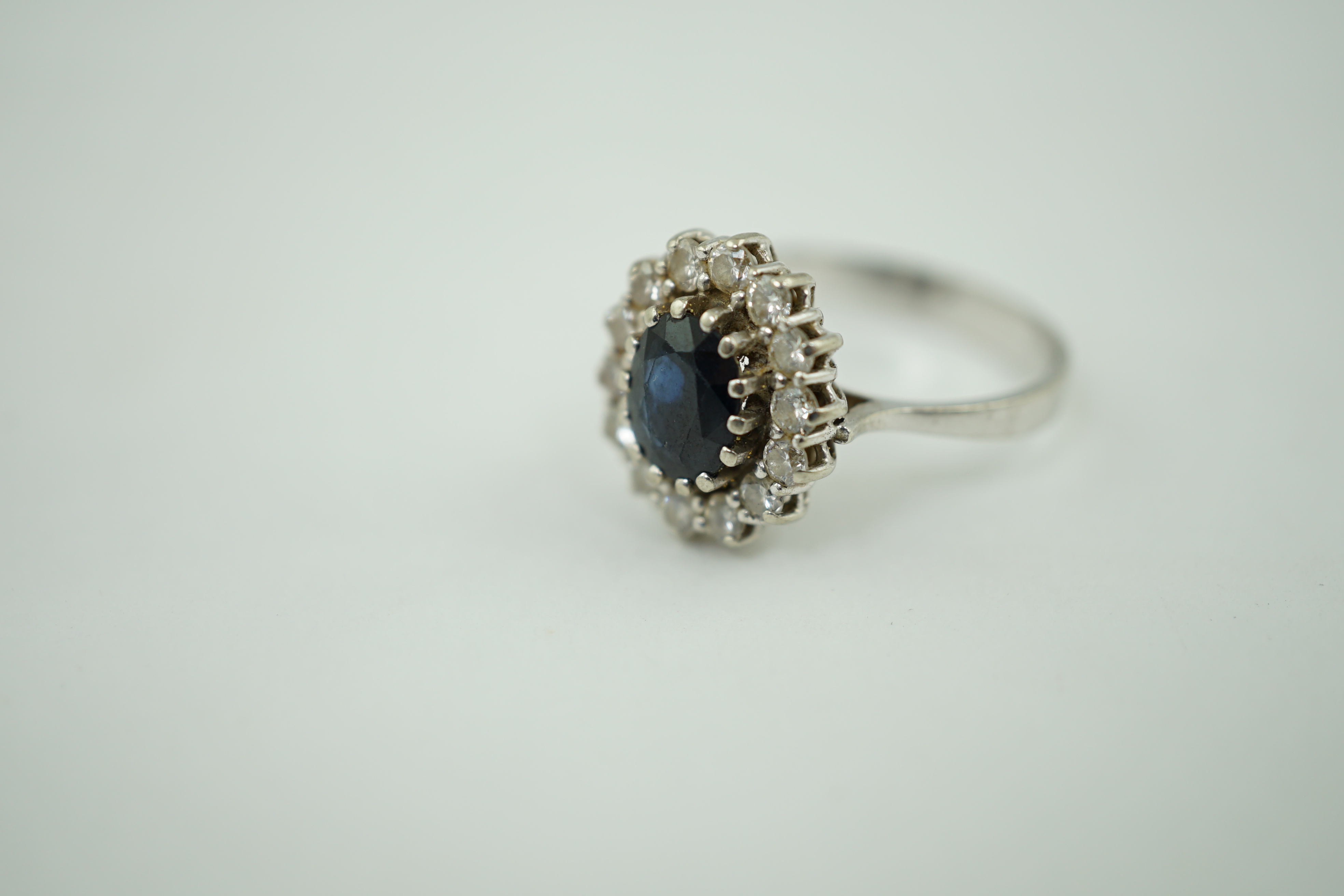 A mid to late 20th century 14k white gold, sapphire and diamond set oval cluster ring